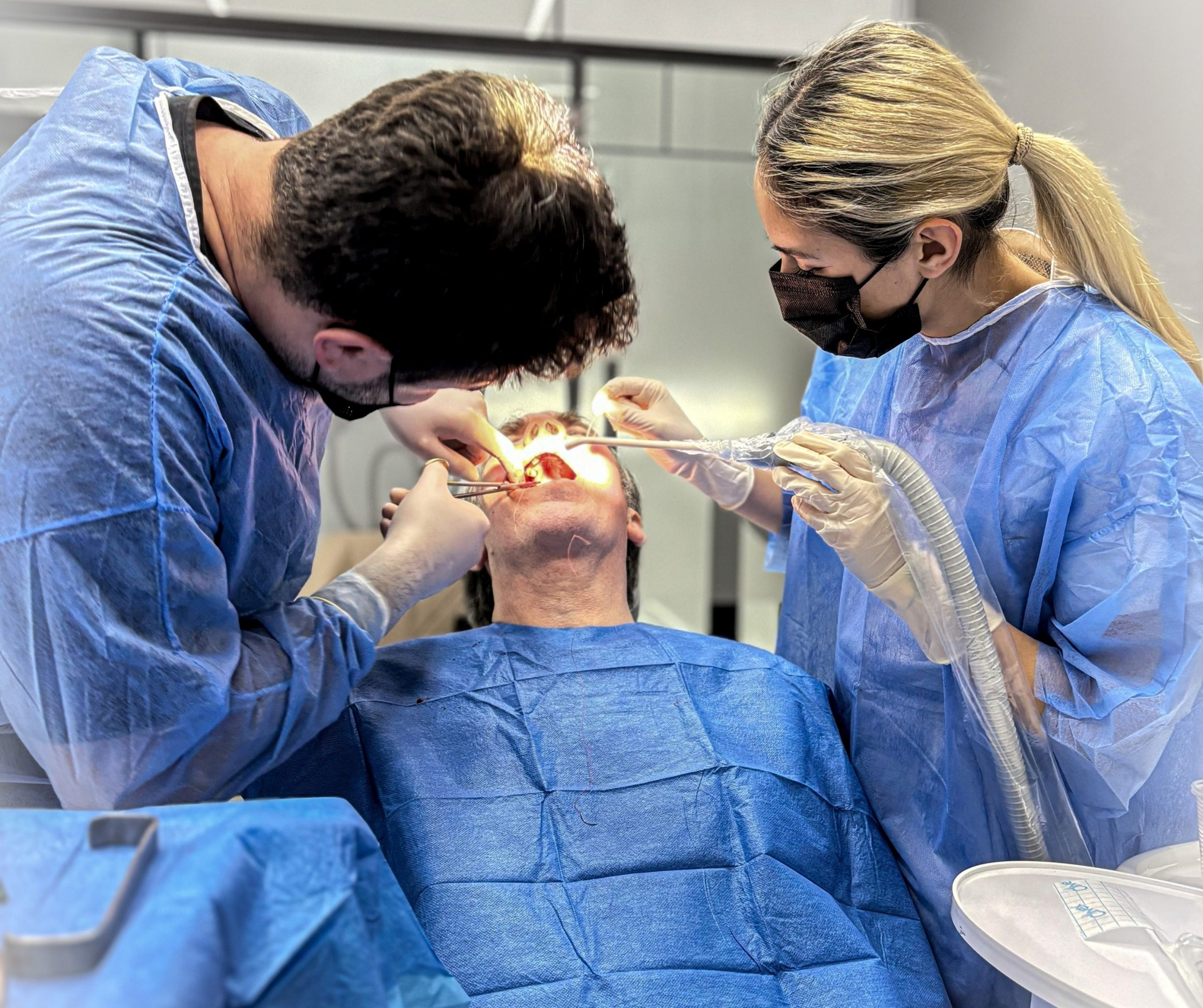 Turkish dentist during dental implant surgery in Turkey